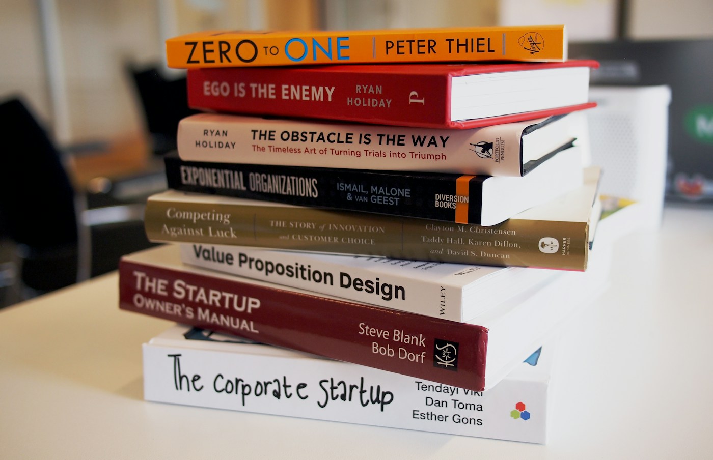 A stack of books arranged on a table